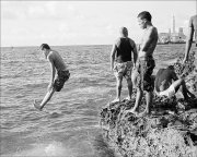 man-jumping-into-sea-from-malecon