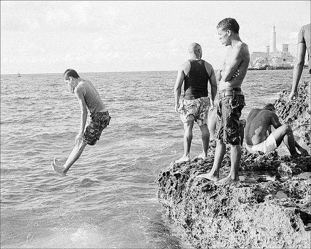 man-jumping-into-sea-from-malecon