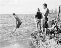 man-jumping-into-sea-from-malecon