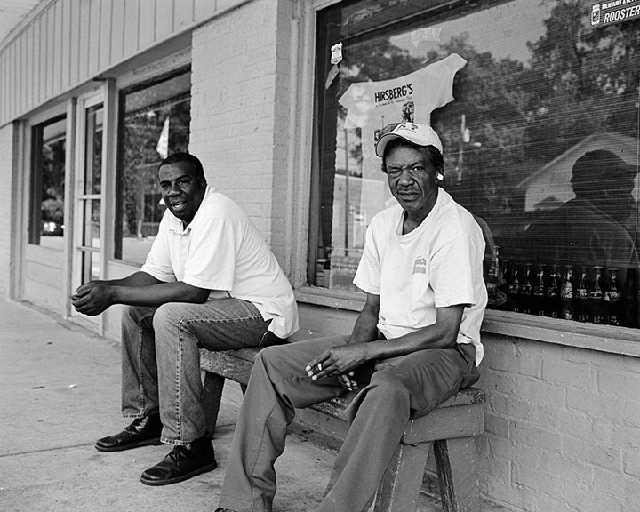 Friars-Point-two-men-on-ben Friars Point MS: Frank James Reddick, on right, explained that he had been shot three times in the head and four times in the chest back 31 years ago. He said he 